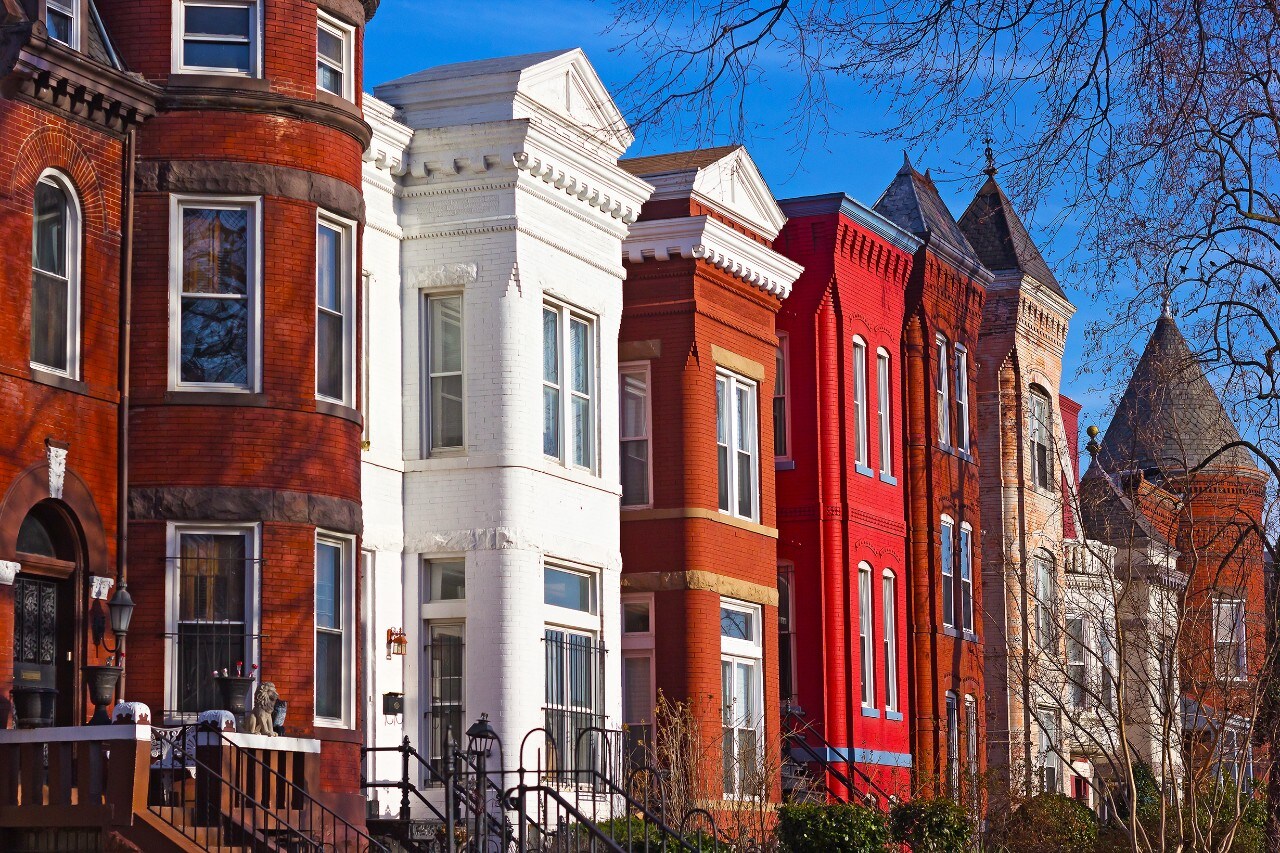 Colorful residential townhouses in the afternoon sun.